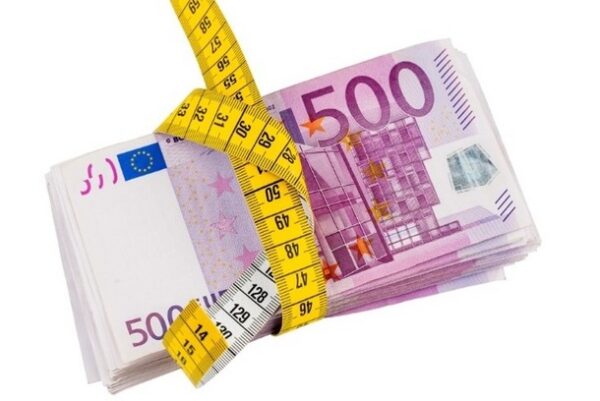 A pile of Euro notes tied up with a measuring tape