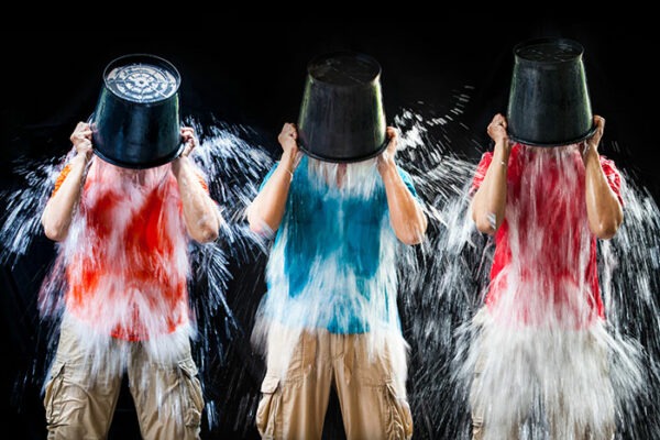3 people pouring water from a bucket over themselves for ice bucket challenge