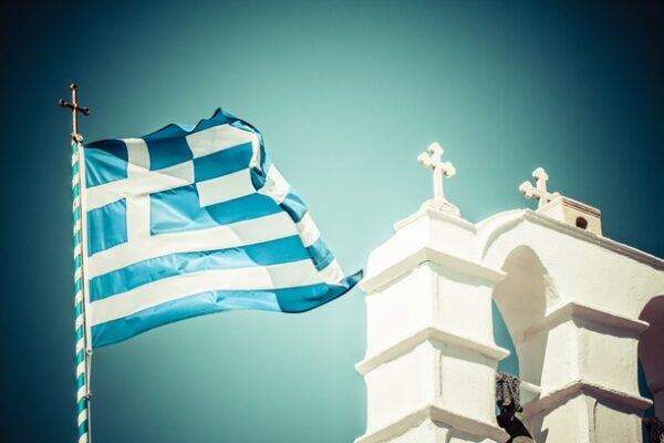 Greek flag next to a white church