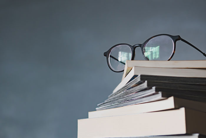 Spectacles on top of a pile of books