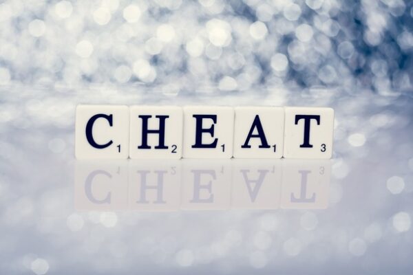 Scrabble tiles on cloud background: CHEAT