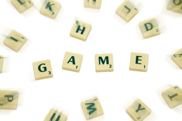 Scrabble tiles with GAME in centre