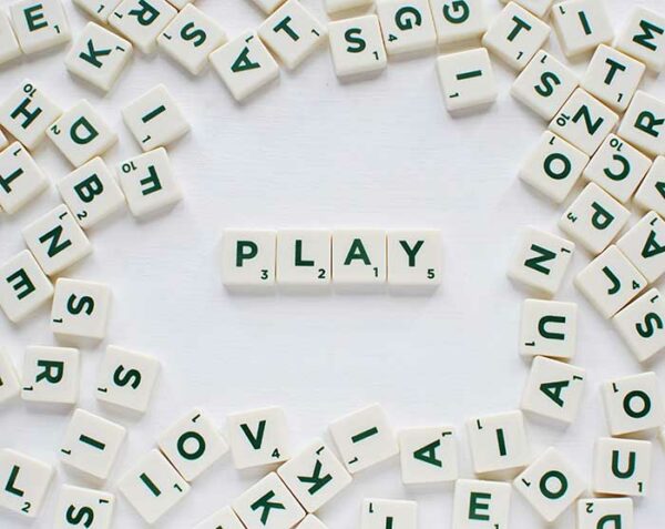 scrabble tiles with word PLAY spelt out