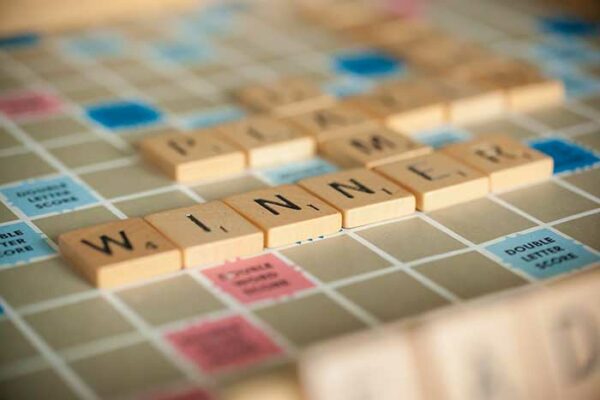 scrabble tiles on board with tiles WINNER placed
